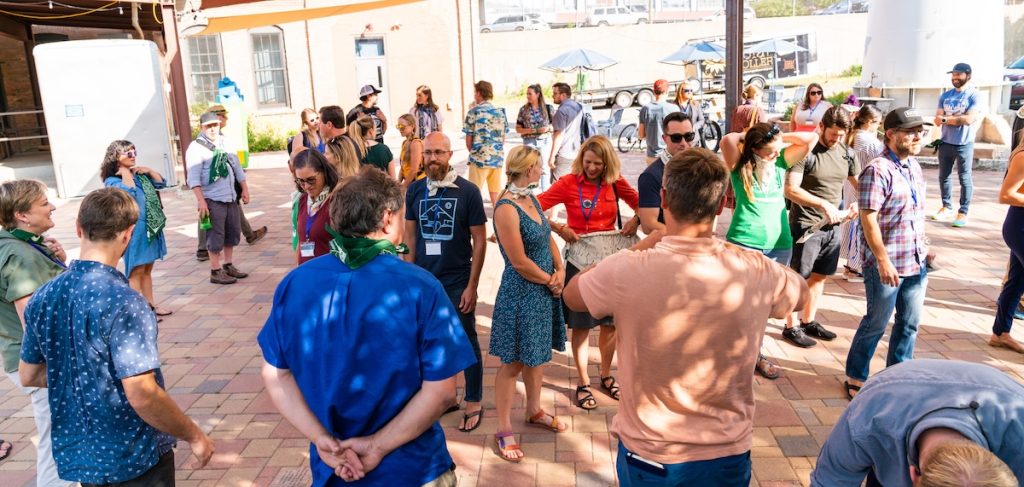 small crowd of people networking outside