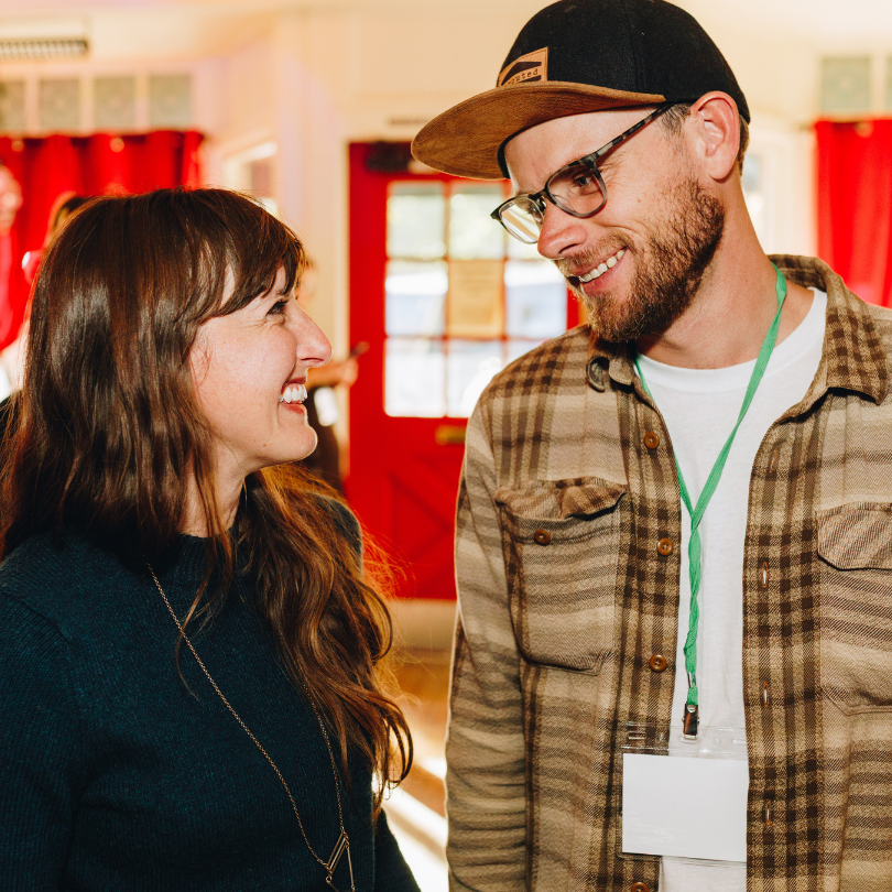 a man and a woman smiling at eachother
